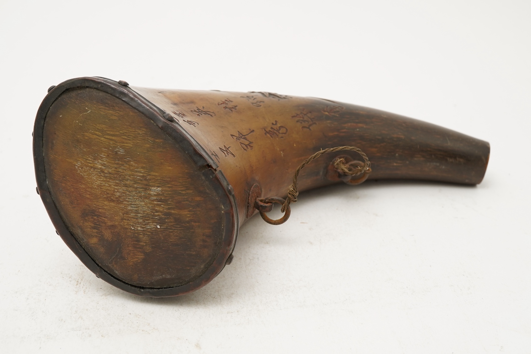 A Tibetan or Mongolian inscribed buffalo horn powder flask, 18th century
